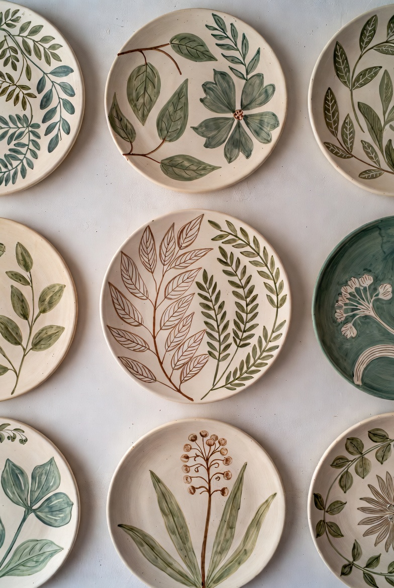 Hand-painted ceramic wall plates with botanical motifs